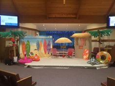 a stage set up for a children's birthday party with surfboards and umbrellas