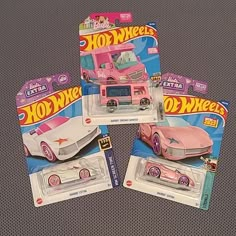 three hot wheels cars are shown in pink and white colors, each with the hood open