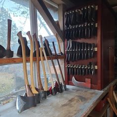 there are many tools on the table in this room, including shovels and tongs