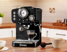 an espresso machine sitting on top of a wooden counter