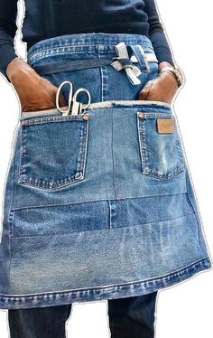 a person wearing a jean skirt with scissors in their pockets and holding the pocket open