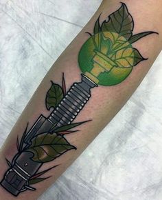 a tattoo on the leg of a person with a green light bulb in it's hand