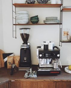 a coffee maker sitting on top of a wooden counter