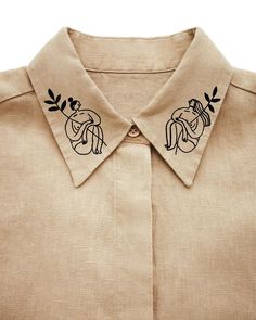 a close up of a shirt with an embroidered design on it