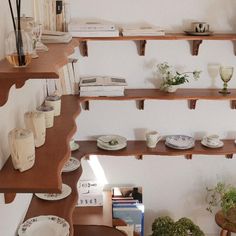 the shelves are filled with dishes and vases on top of them, along with other items