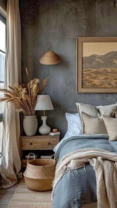 a bedroom with gray walls and blue bedding in the corner, an art work on the wall