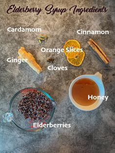 the ingredients for elderberry syrup are shown on a gray surface with orange slices, cinnamon, cloves and honey