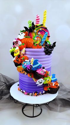 a multi layer cake decorated with halloween decorations