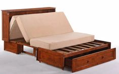 a wooden bed frame with two drawers and a pull out mattress in the bottom drawer