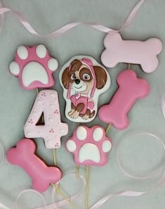 a dog themed cake topper with pink and white icing