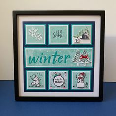 a framed christmas card with snowmen and winter sayings on the front in black frame