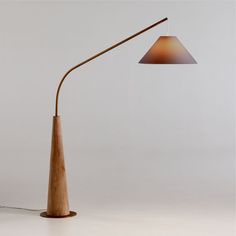 a lamp that is on top of a wooden pole and has a light attached to it