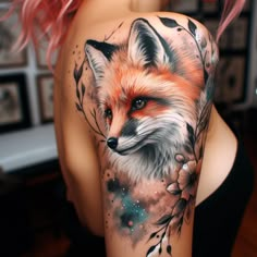 a woman's arm with a fox and flowers tattoo on her left side shoulder