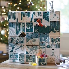 a bunch of boxes that are sitting on a table next to a christmas tree and some candy