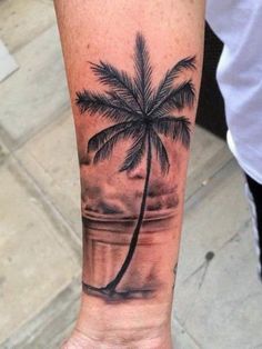 a person with a palm tree tattoo on their arm