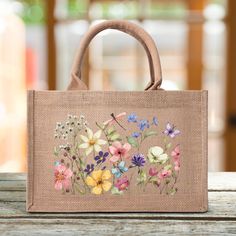 a bag with flowers painted on it sitting on a table