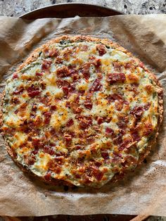 a pizza sitting on top of a piece of wax paper