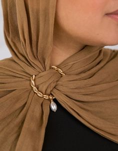 Enhance your hijab with an elegant touch that never goes out of style. This stunning gold hoop features a graceful dangling pearl, offering a luxurious addition to your look. This design captures the essence of timeless beauty, with dimensions meticulously crafted to keep your scarf perfectly positioned. Embrace the allure of gold and pearls with this exquisite accessory. Hijab Jewelry, Instant Hijab, Gold Hoop, Silk Chiffon, Out Of Style, Timeless Beauty, Going Out, Twist, Gold