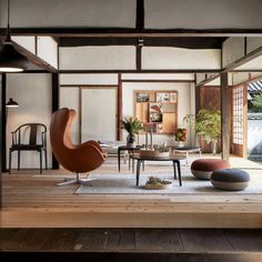 a living room filled with furniture and lots of wooden flooring on top of a hard wood floor