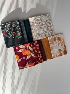 four different types of cloths laid out on top of each other, all in various colors and patterns