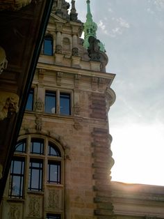 a tall building with a clock on the top of it's face and windows