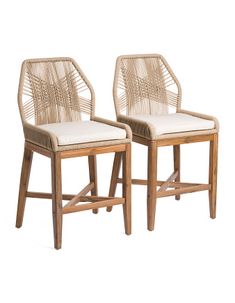 two wicker chairs sitting next to each other on a white background with no one in the photo