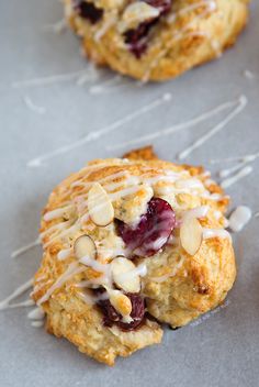 two scones with almonds and cranberries on top