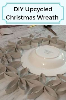 a white plate sitting on top of a table covered in paper flowers and ribbon around it