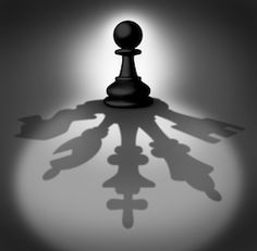 the shadow of a chess piece is cast on a dark surface with light coming from behind it