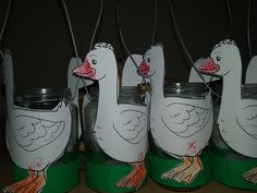 four painted cans with ducks on them sitting next to each other