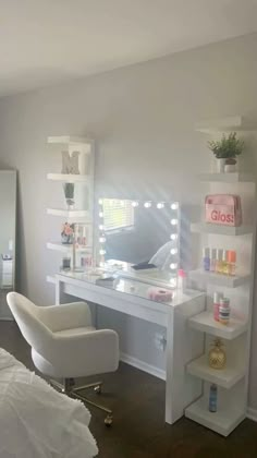 a bedroom with a vanity, chair and mirror on the wall in front of it