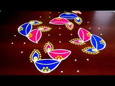 colorful rangdi work on wooden table for diwaling with flowers and dots in the middle