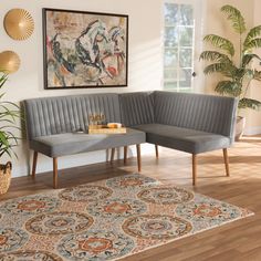 a living room with two couches and a rug in front of a painting on the wall