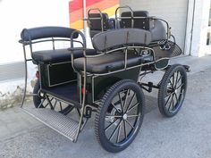 an old fashioned car parked in front of a building