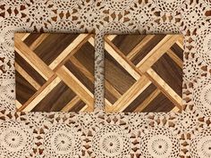 two wooden coasters sitting on top of a doily