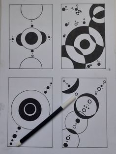 some black and white circles are on top of a piece of paper with a marker