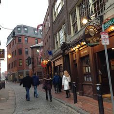 people walking down the street in front of buildings