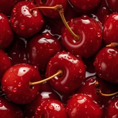 cherries with water droplets on them are shown in this close up photo, which appears to have been taken from above