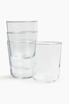 three clear glasses sitting next to each other