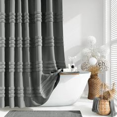 a bathroom with a bathtub, rug and shower curtain in black and white colors