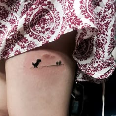 a woman's thigh with a small dog tattoo on it