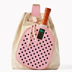 a pink and white bag with a wine bottle in the bottom pocket, on a white background