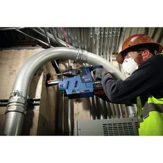 a man in safety gear working on pipes