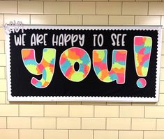 there is a sign that says we are happy to see you on the wall in this public restroom