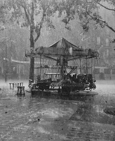 an old black and white photo of people on a boat in the water with umbrellas