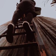 a man riding a skateboard down the side of a metal rail on top of a wooden ramp