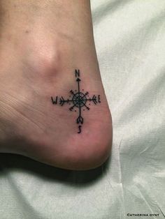 a person with a compass tattoo on their foot