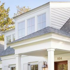 a house with white siding and brown doors