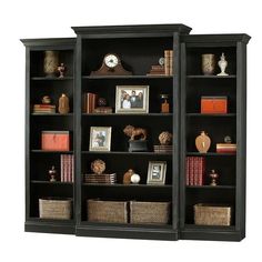 two black bookcases with books and pictures on them