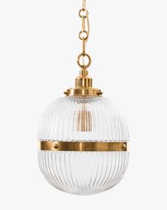 a glass globe light hanging from a brass chain on a white background with clippings